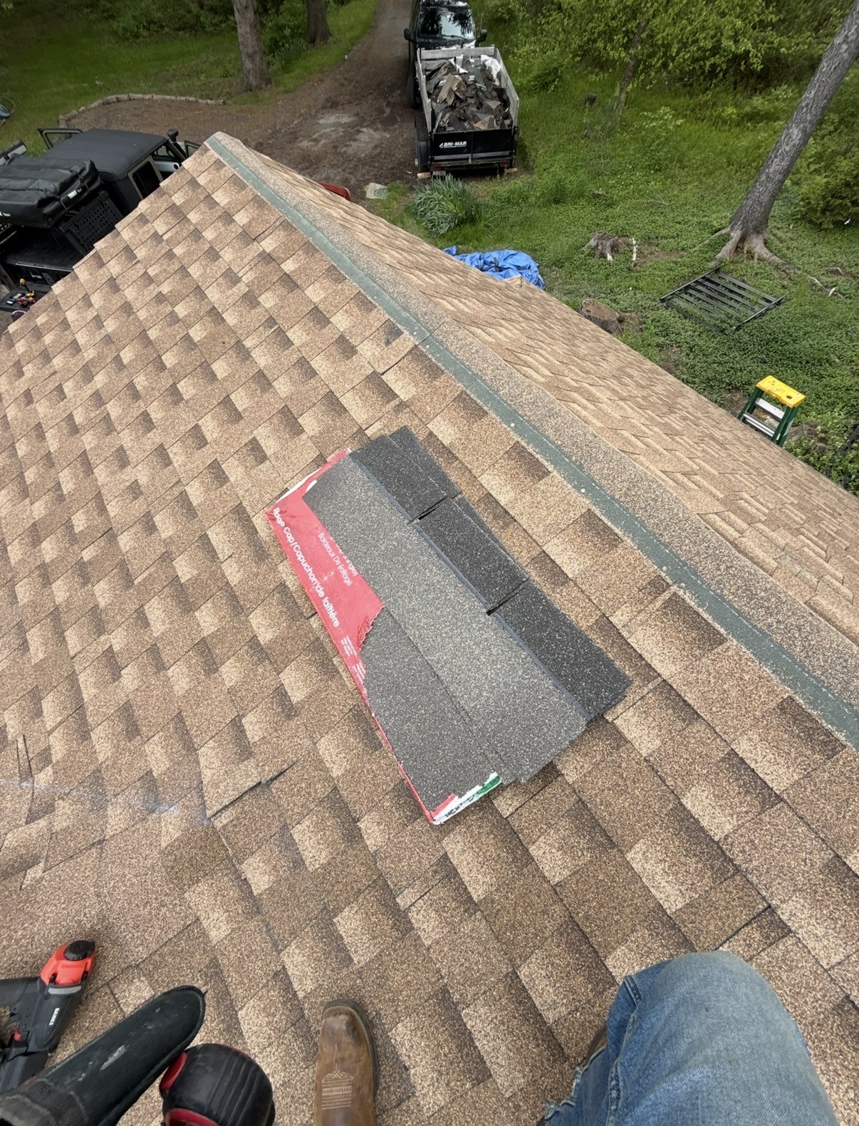 Shingled roof with a repair area and tools