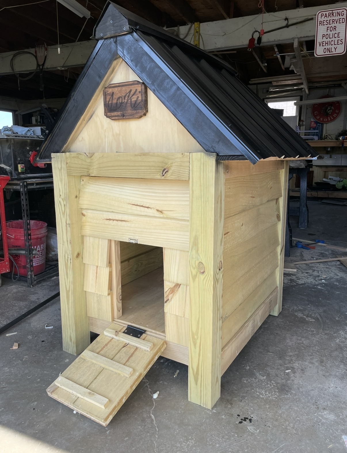 Small wood structure with a pitched roof and hinged ramp