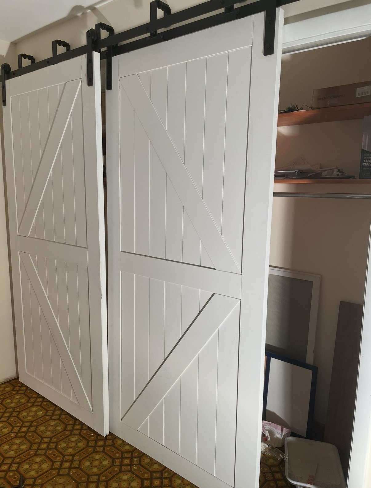 White double barn doors on black sliding hardware